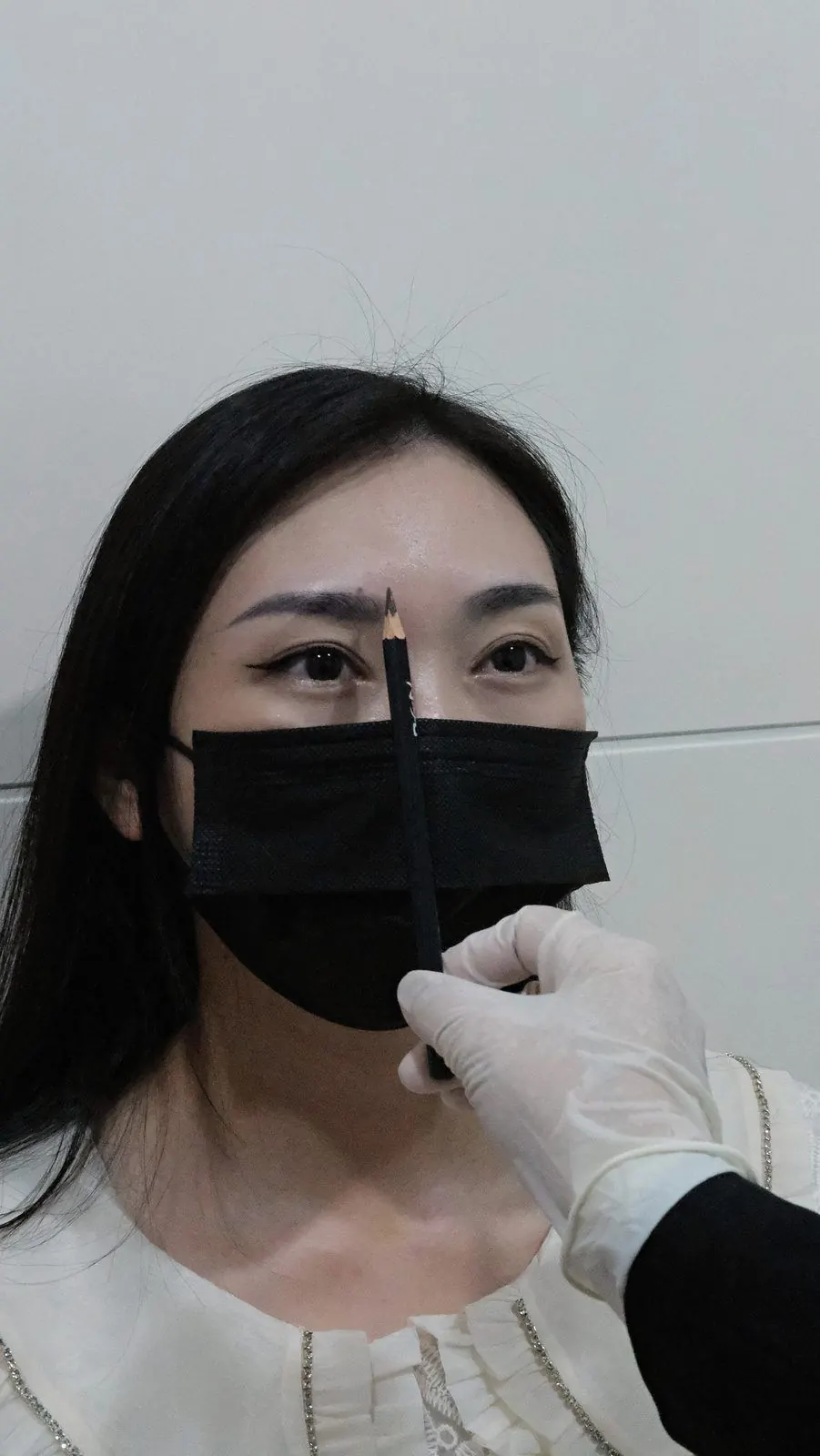 Brow artist mapping a client's brows