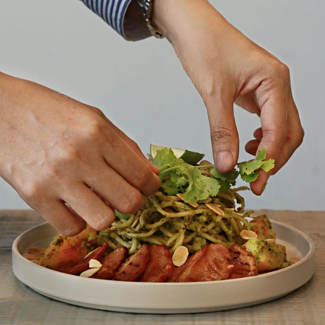 Pesto pasta being plated
